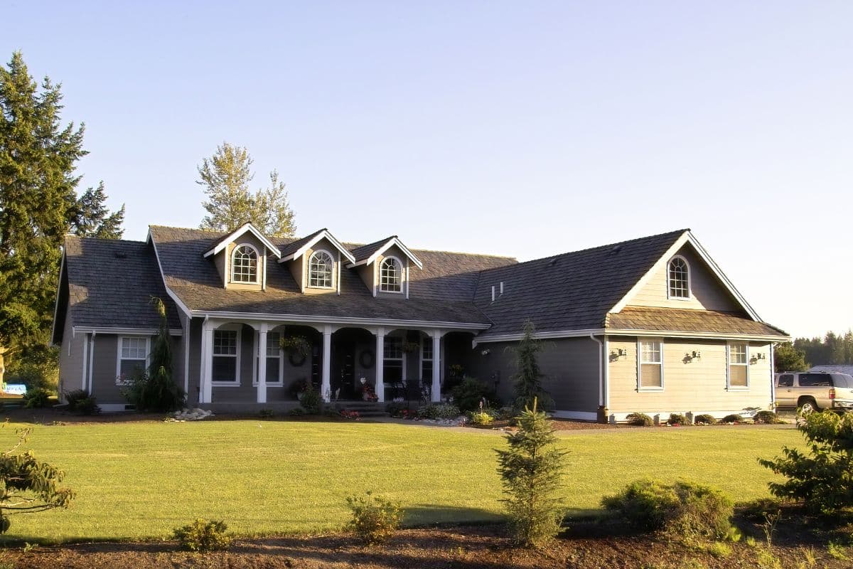 Home inspector and homebuyer examining a residential wellhead on a rural property during a pre-purchase well inspection