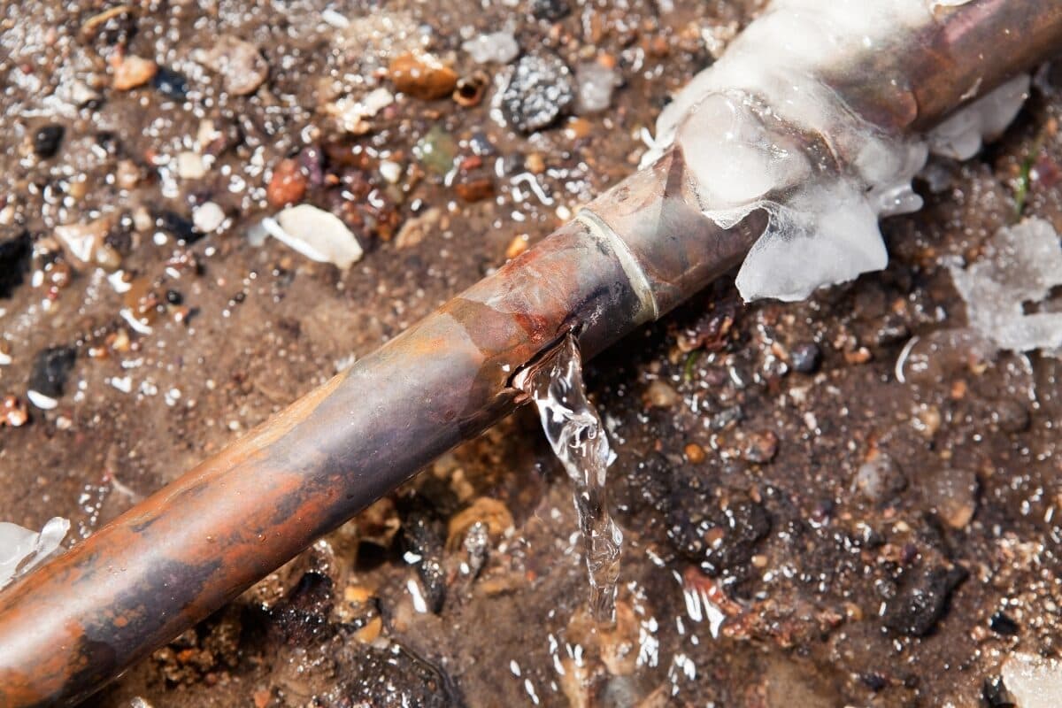 Frozen pipe and pressure switch next to a well pressure tank.
